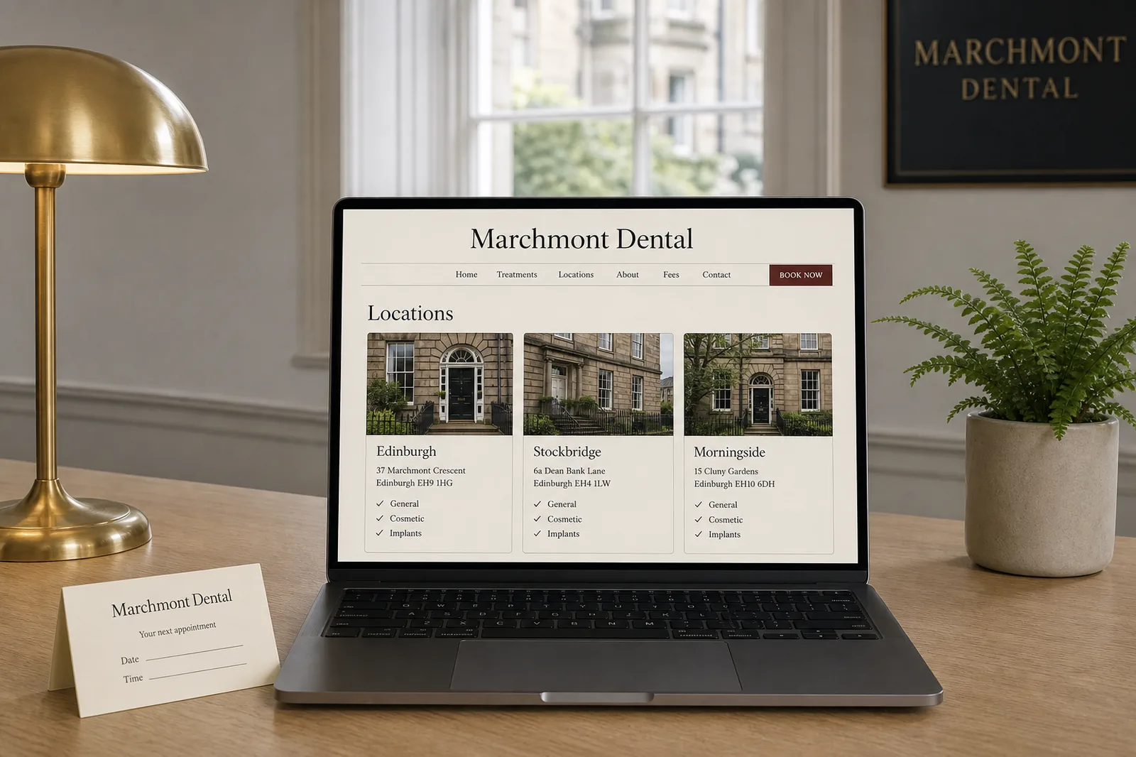 Laptop on a reception desk showing Marchmont Dental location pages for Edinburgh, Stockbridge and Morningside